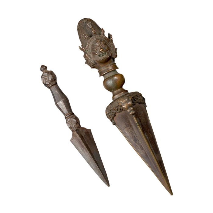 A group of seven silver repoussé amulets and a gilt copper alloy hair ornament